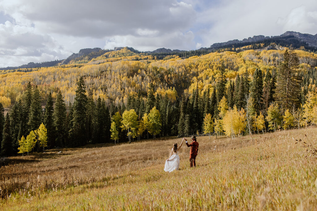 Bride and Groom dance in the autumn plains of a Breckenridge Mountain top during their Elopement Ceremony. 