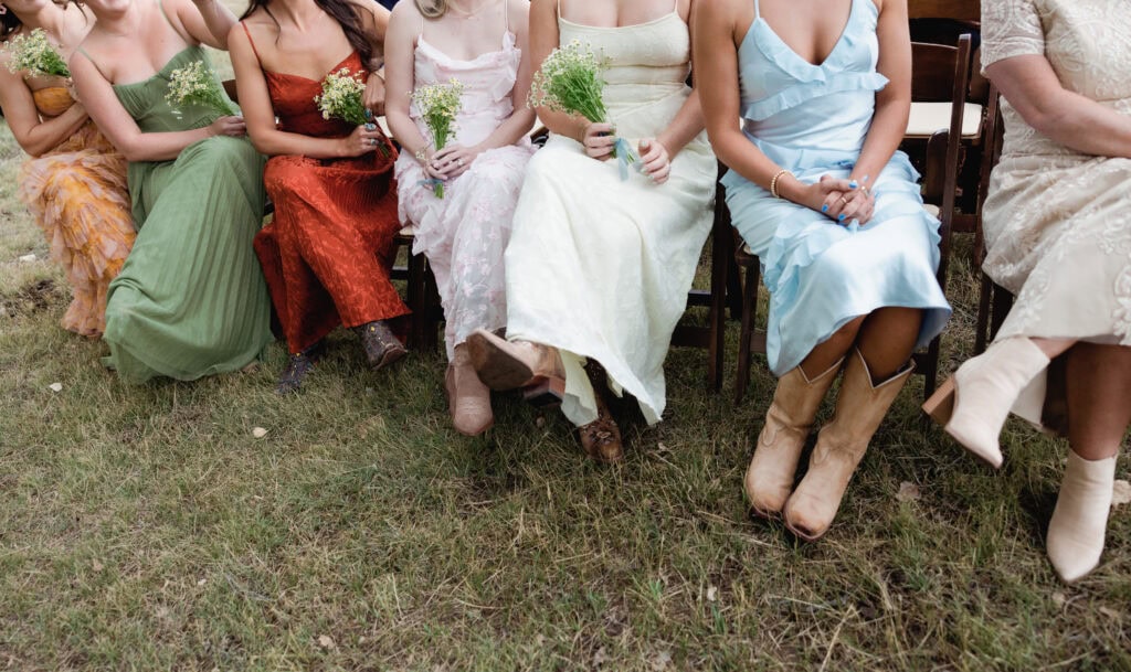 bridesmaids in cowgirl boots at outdoor wedding in colorado 